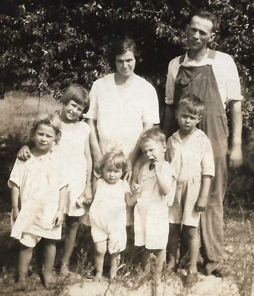 Homesteaders Mabel and Victor Johnson and family (seen here in 1931) took out a bank mortgage before the Great Crash of 1929 and struggled to make payments throughout the Great Depression until Rosie (second from left) sent her earnings home and paid off the mortgage during World War II. The Victor Johnson family in 1931. Left to right: Mary, Rosie, Joyce, Fred and Victor Junior stand before their parents Mabel and Victor Johnson of Chief, Michigan.