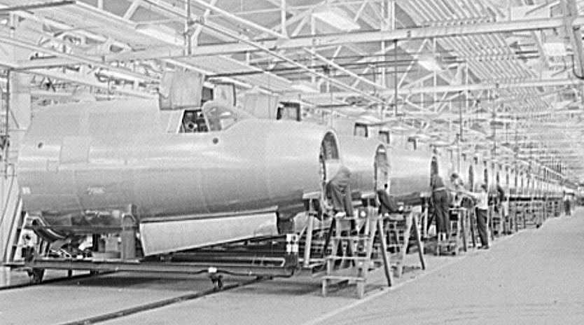 October 1942: De Soto bomber plant, Detroit, Michigan. Nose section of B-26 bomber showing conveyor line running on the floor. Siegel, Arthur S., photographer